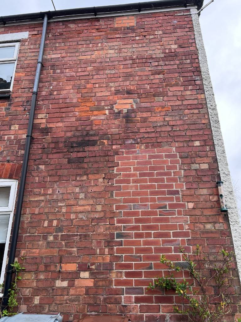 Brick façade with fresh repointing patch