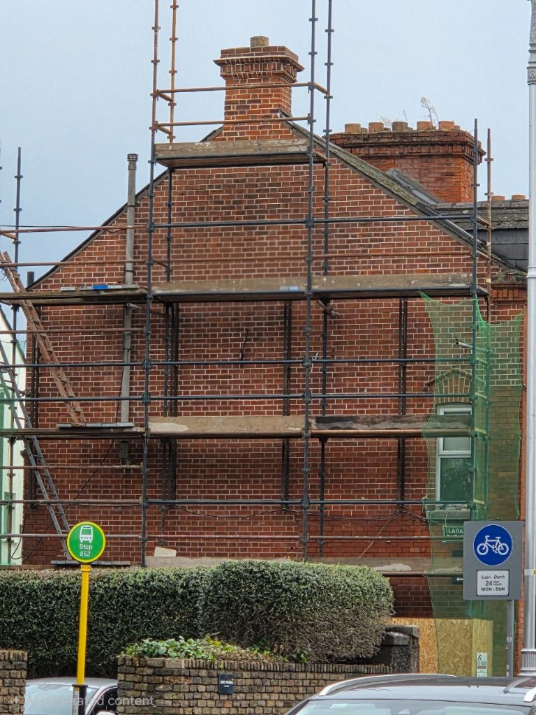 Brick gable repointing on scaffolding at a Dublin house